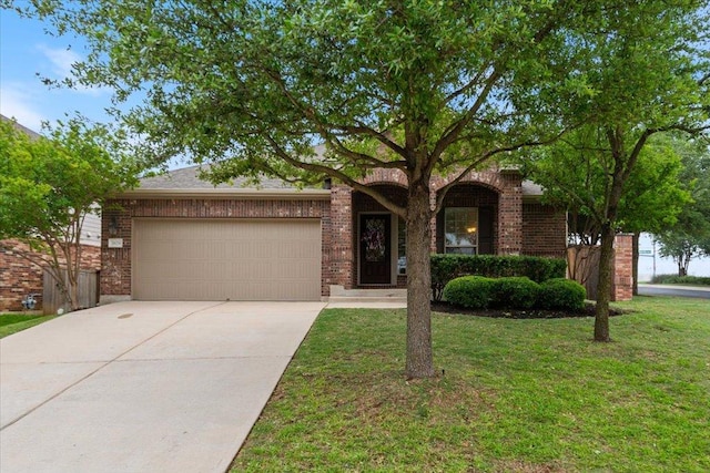 view of front facade with brick siding, a garage, a front lawn, and concrete driveway