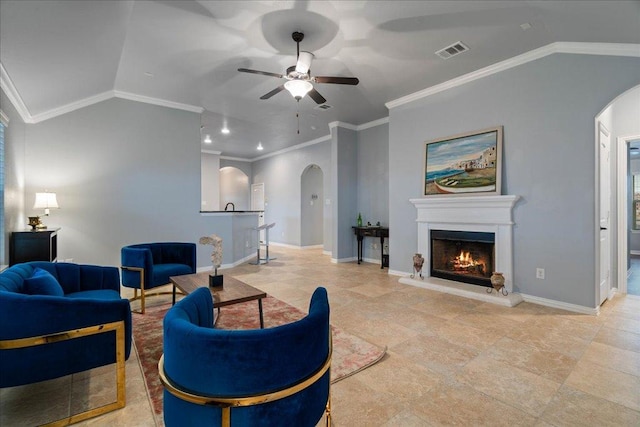 living area with ceiling fan, arched walkways, baseboards, vaulted ceiling, and visible vents