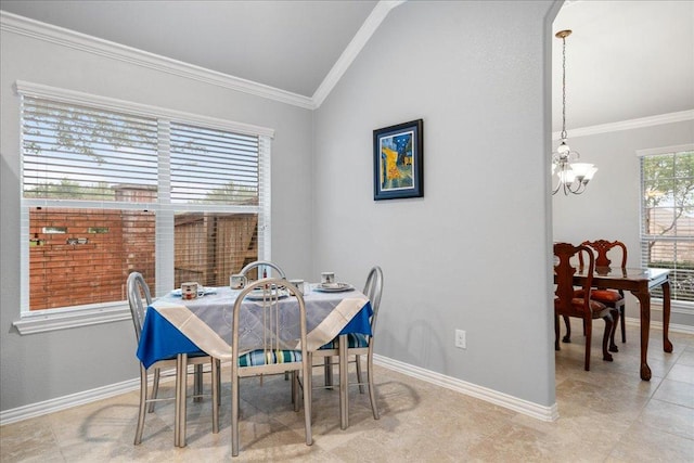 dining room with baseboards, crown molding, lofted ceiling, and a chandelier