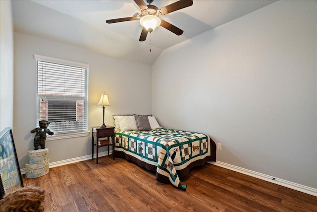 bedroom featuring baseboards, a ceiling fan, vaulted ceiling, and wood finished floors