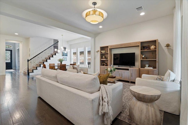 living room with recessed lighting, dark wood-type flooring, stairs, and visible vents