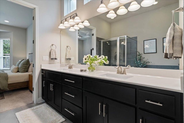 bathroom featuring double vanity, a sink, connected bathroom, and a stall shower