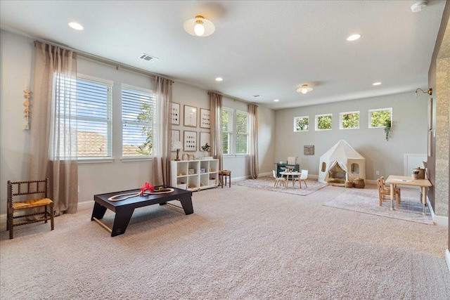 rec room featuring plenty of natural light, carpet flooring, and visible vents