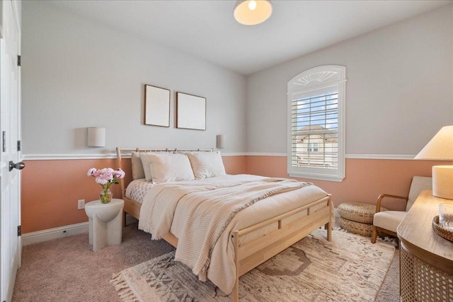 carpeted bedroom featuring baseboards
