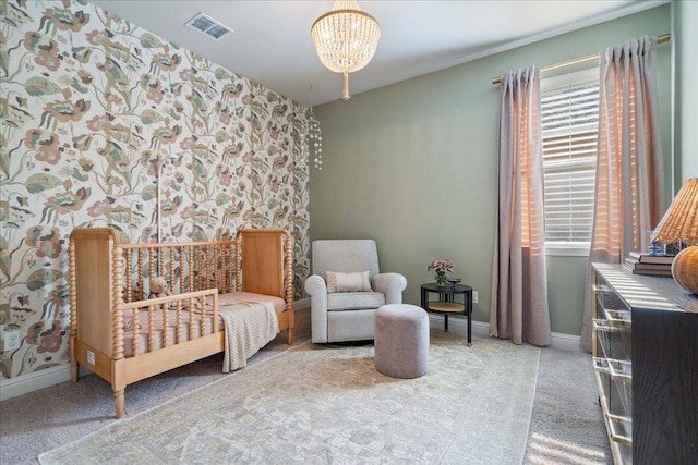 carpeted bedroom with a chandelier, baseboards, visible vents, and wallpapered walls