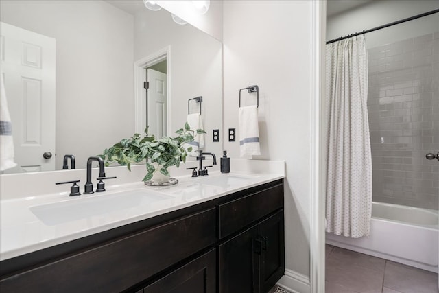 bathroom with a sink, tile patterned floors, double vanity, and shower / tub combo