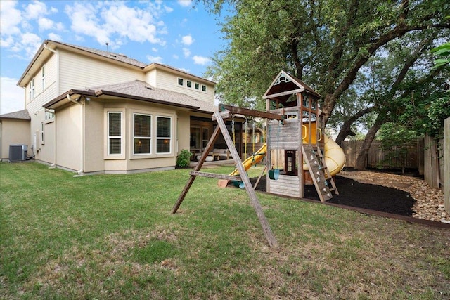5305 Allamanda Dr, Austin, TX 78739 - back of property featuring central AC unit, a playground, and roof with shingles