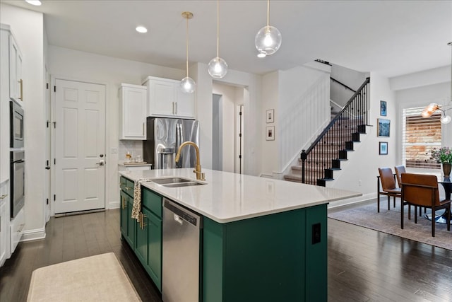 kitchen with dark wood-style floors, green cabinetry, white cabinets, a sink, and appliances with stainless steel finishes