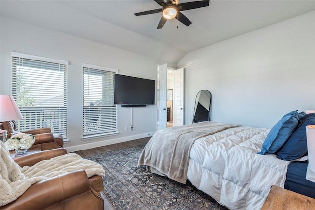 bedroom featuring wood finished floors, a ceiling fan, baseboards, and lofted ceiling
