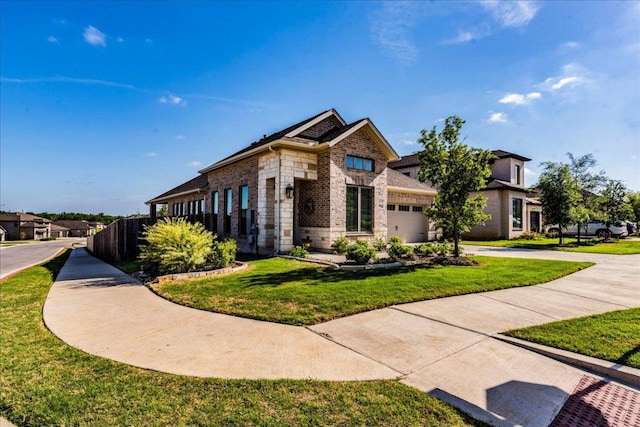 view of front of property with driveway, a garage, brick siding, fence, and a front lawn