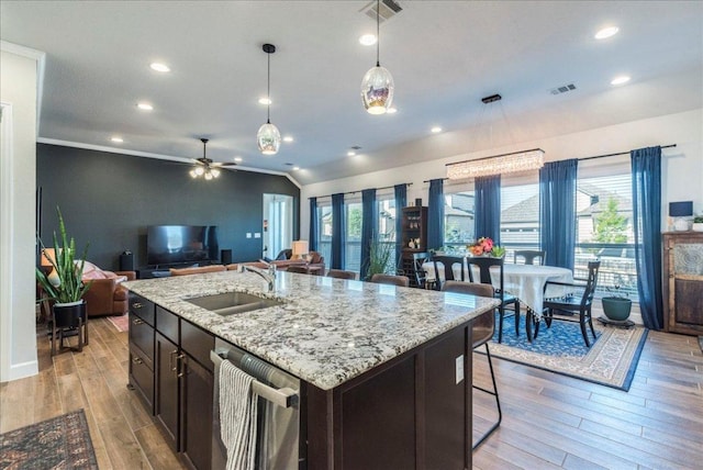 kitchen with visible vents, a sink, light wood-style flooring, and dishwasher
