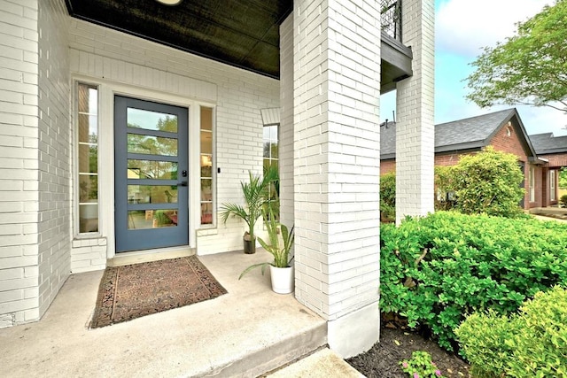 doorway to property with brick siding
