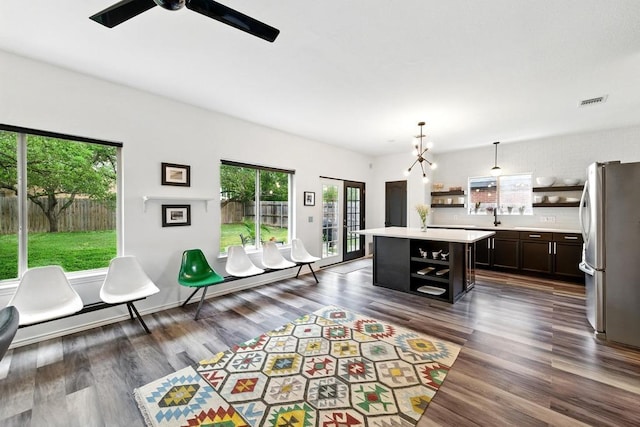 interior space featuring dark wood-type flooring, a wealth of natural light, and visible vents