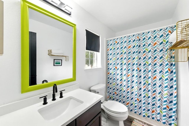 bathroom featuring toilet, a shower with curtain, and vanity