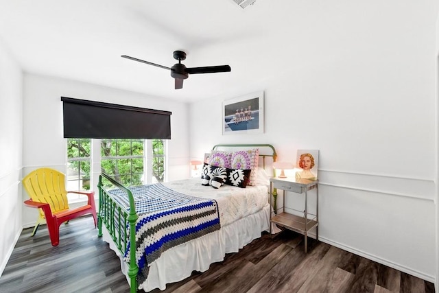 bedroom with baseboards, dark wood finished floors, and ceiling fan