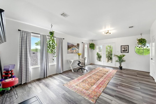 bedroom featuring visible vents and wood finished floors