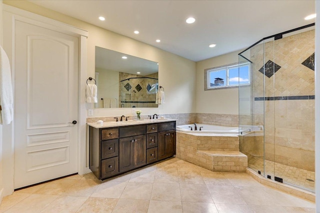 bathroom with vanity, a shower stall, a garden tub, and recessed lighting