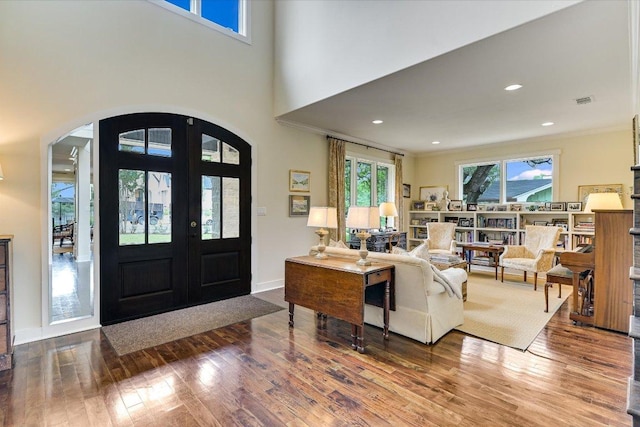 2401 Westover Rd, Austin, TX 78703 - entrance foyer with arched walkways, wood finished floors, french doors, recessed lighting, and baseboards