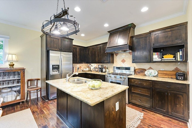 kitchen featuring dark brown cabinetry, appliances with stainless steel finishes, dark wood finished floors, a sink, and light stone counters