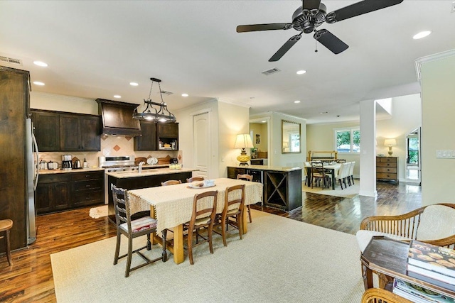dining area with recessed lighting, ornamental molding, and visible vents