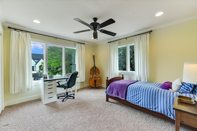 carpeted bedroom featuring baseboards, ornamental molding, and multiple windows