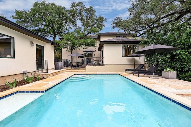 view of pool featuring a patio, a fenced in pool, and fence