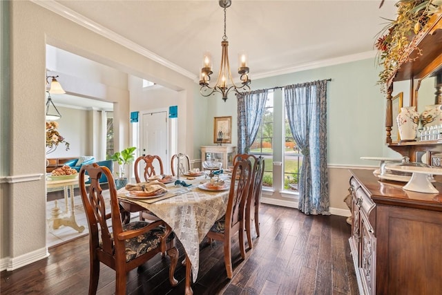 dining area with baseboards, ornamental molding, dark wood finished floors, and a notable chandelier