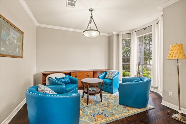 sitting room featuring visible vents, baseboards, crown molding, and wood finished floors