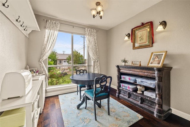 dining room with baseboards and dark wood-style floors