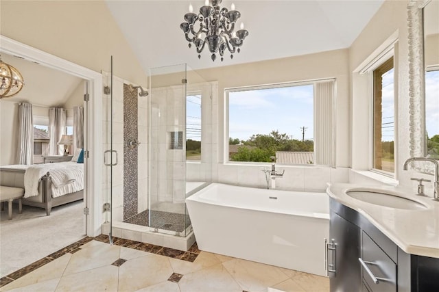 ensuite bathroom featuring connected bathroom, an inviting chandelier, lofted ceiling, and a stall shower