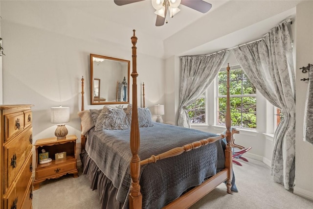 bedroom with baseboards, a ceiling fan, and light carpet