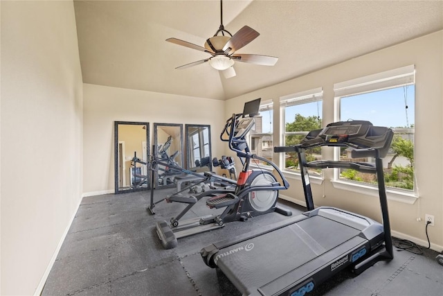 workout area with baseboards, ceiling fan, and lofted ceiling