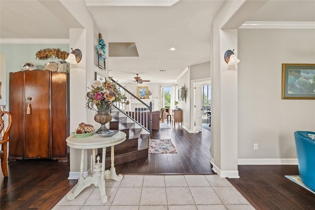 entrance foyer with ornamental molding, baseboards, stairway, hardwood / wood-style flooring, and a ceiling fan