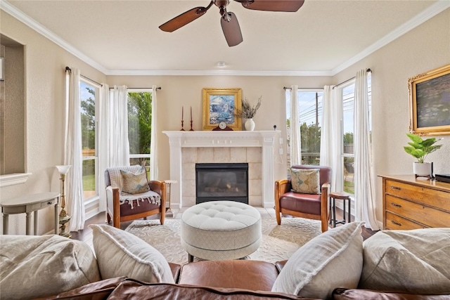 living area with ornamental molding, ceiling fan, and a wealth of natural light