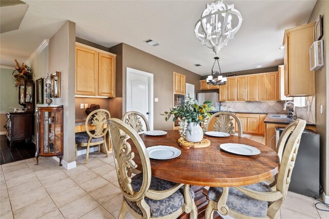 dining room with visible vents, baseboards, light tile patterned flooring, and a notable chandelier