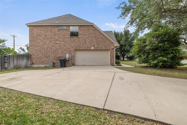 100 S Ridge Cir, Georgetown, TX 78628 - view of side of property with driveway, an attached garage, brick siding, and roof with shingles