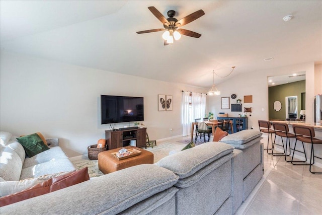 living room featuring light tile patterned floors, baseboards, ceiling fan, and vaulted ceiling