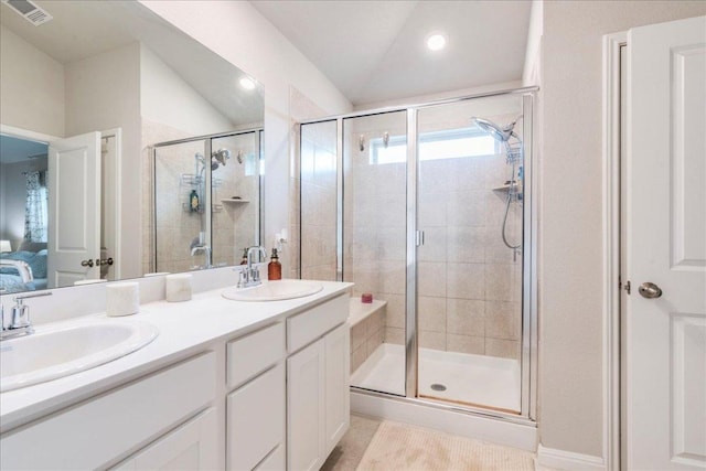 268 Forrest Moon Ln, Kyle, TX 78640 - ensuite bathroom featuring lofted ceiling, a shower stall, double vanity, and recessed lighting