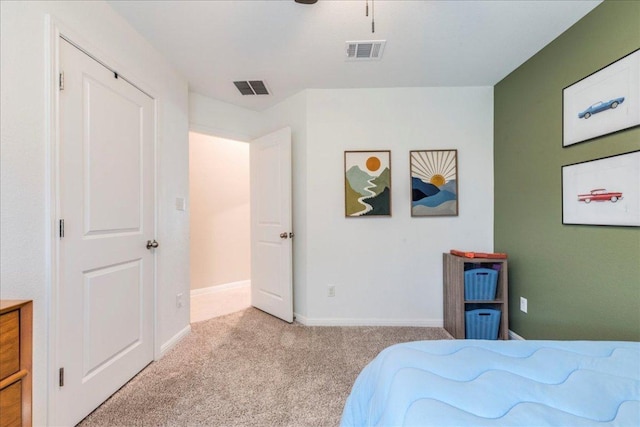 carpeted bedroom featuring a ceiling fan, baseboards, and visible vents