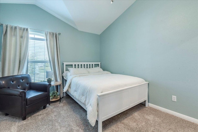 bedroom featuring baseboards, carpet, multiple windows, and lofted ceiling
