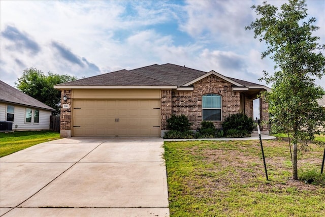 ranch-style house featuring an attached garage, concrete driveway, a front yard, and brick siding