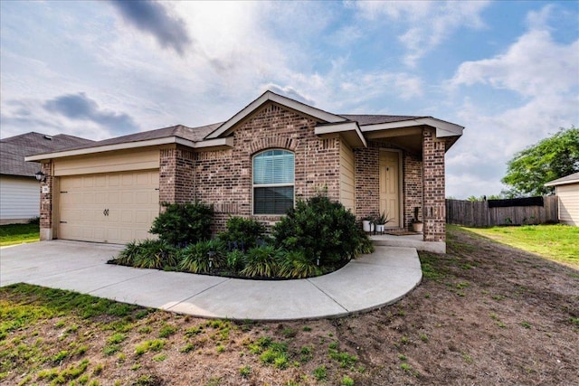 ranch-style house featuring fence, an attached garage, driveway, and brick siding