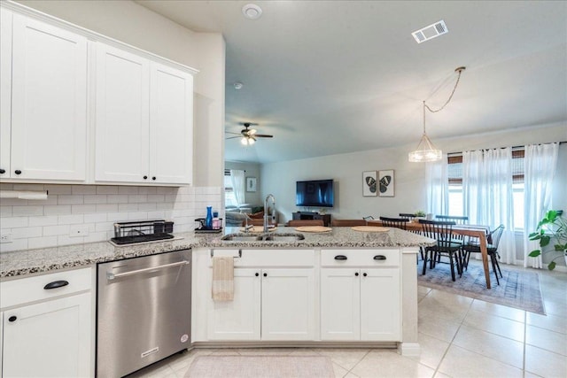 kitchen with stainless steel dishwasher, visible vents, a peninsula, white cabinets, and a sink