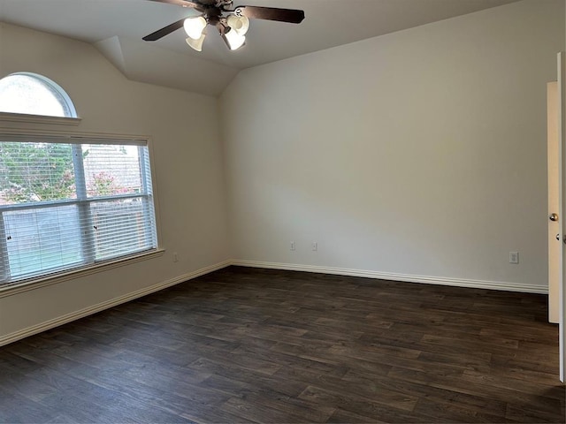 spare room featuring vaulted ceiling, baseboards, a ceiling fan, and dark wood-type flooring