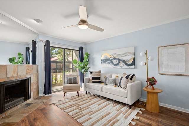 8888 Tallwood Dr Unit 1110, Austin, TX 78759 - living area with crown molding, wood finished floors, baseboards, ceiling fan, and a tile fireplace