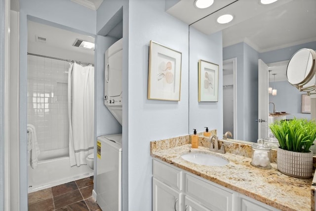8888 Tallwood Dr Unit 1110, Austin, TX 78759 - full bathroom featuring crown molding, stacked washer / drying machine, shower / tub combo with curtain, vanity, and toilet