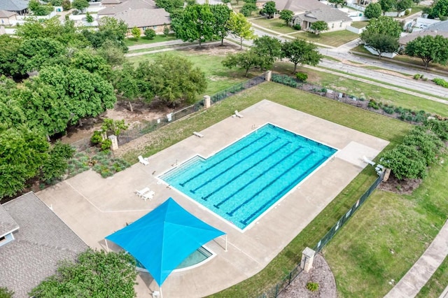 view of pool with fence and a residential view