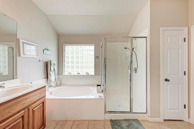 full bath with tile patterned floors, lofted ceiling, and a stall shower