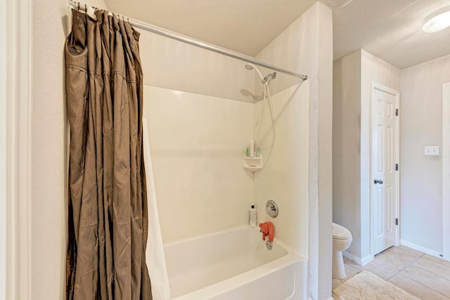 full bathroom with tile patterned flooring, baseboards, shower / bathtub combination with curtain, and toilet