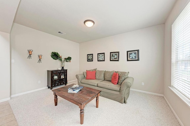 living room with baseboards, light colored carpet, and visible vents